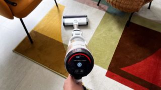 Shark Cordless Detect Pro vacuum being used on a rug