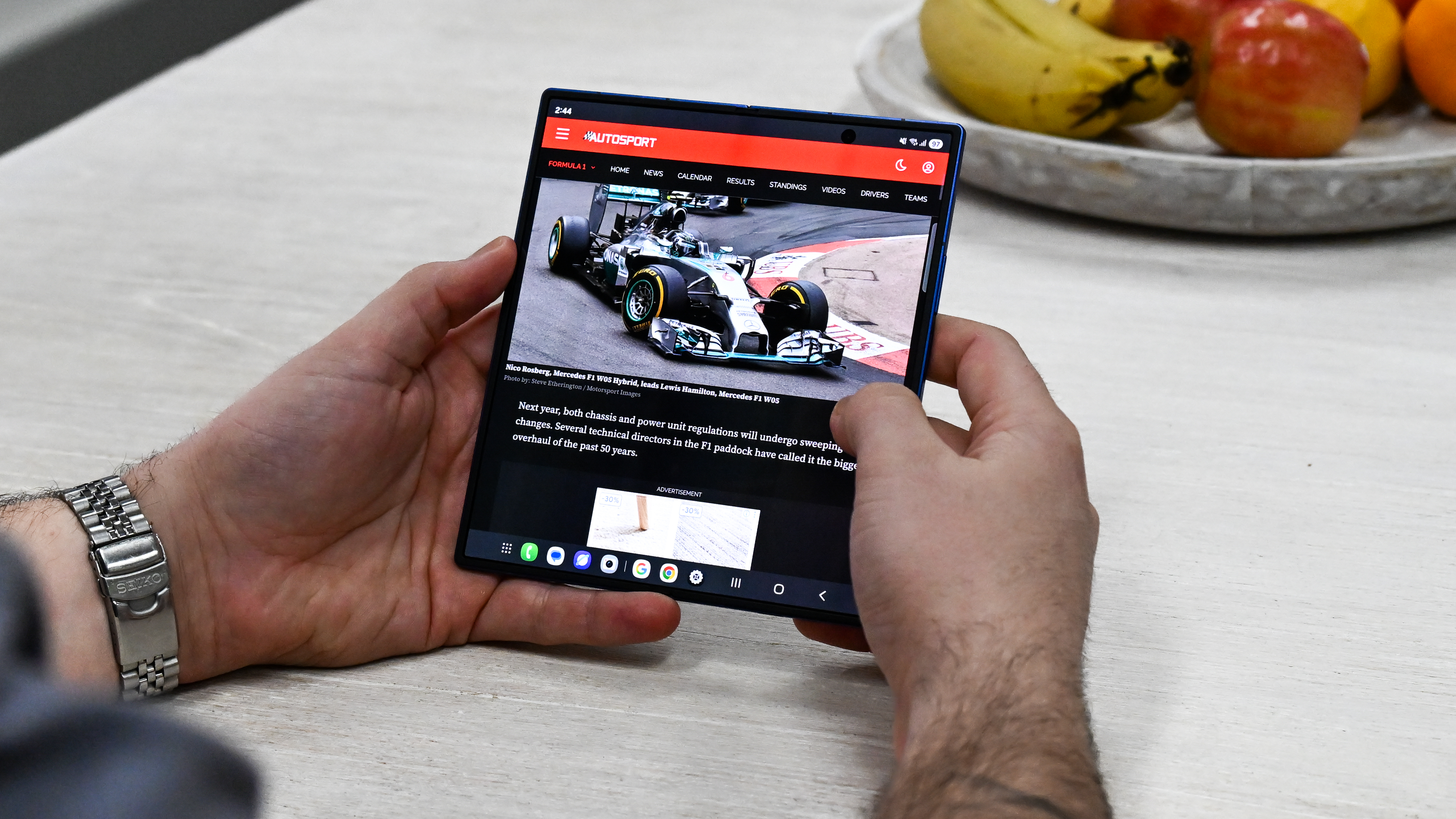 Someone using the Samsung Galaxy Z Fold 7 when unfolded, with news articles on the screen.