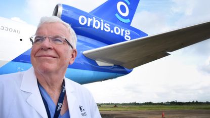 Dr. Lee Alward stands in front of an Orbis International jet.