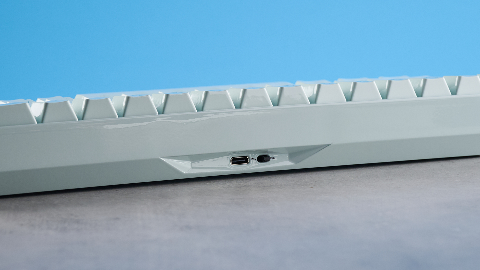 The Keychron Q16 HE 8K in light green on a stone surface