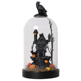 A halloween light with a spooky scene inside of it