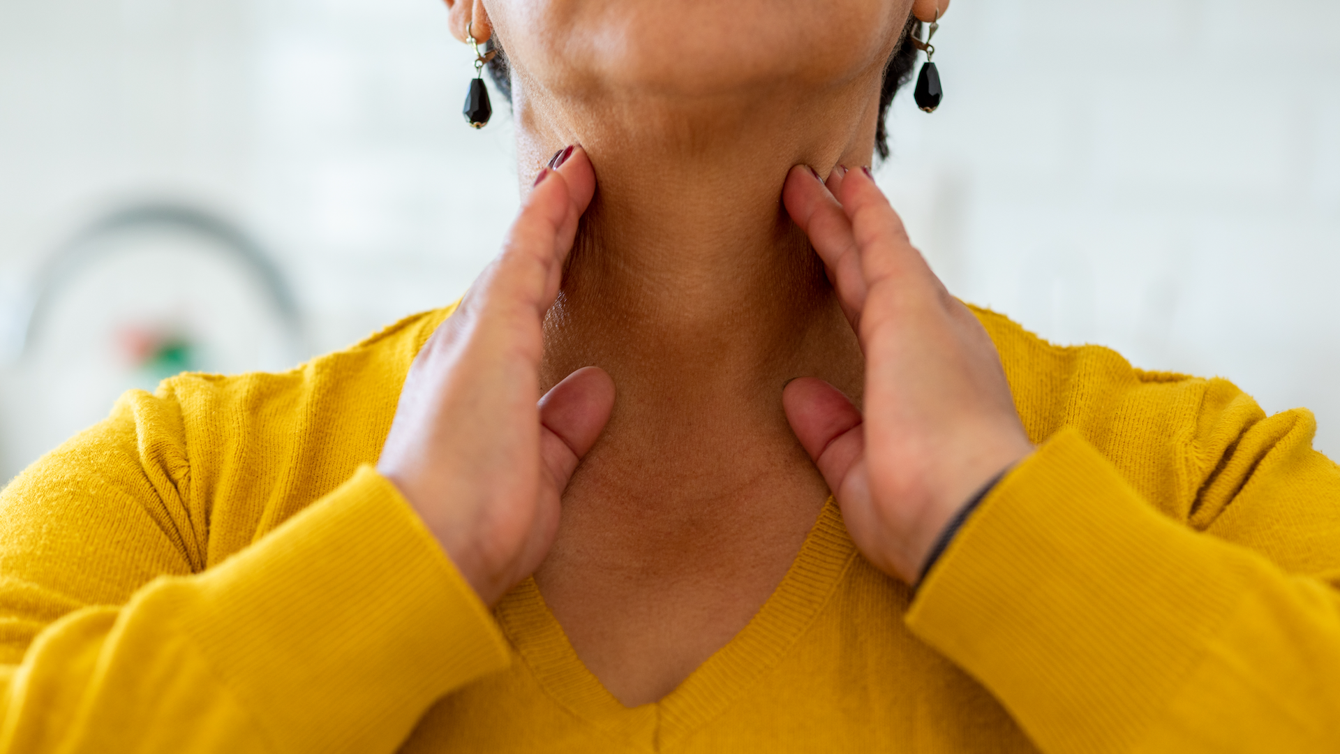 Woman holding her throat
