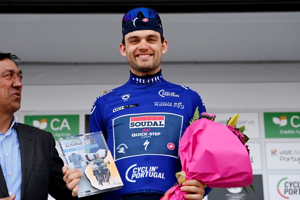 LAGOAPRAIA DO CARVOEIRO ALGARVE PORTUGAL FEBRUARY 19 Kasper Asgreen of Denmark and Team Soudal QuickStep celebrates at podium as Blue Mountain Jersey winner during the 49th Volta ao Algarve em Bicicleta 2023 Stage 5 a 244km individual time trial stage from Lagoa to Lagoa VAlgarve2023 on February 19 2023 in Lagoa Algarve Portugal Photo by Tim de WaeleGetty Images