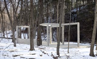 A concrete structure standing in a snowy woodland