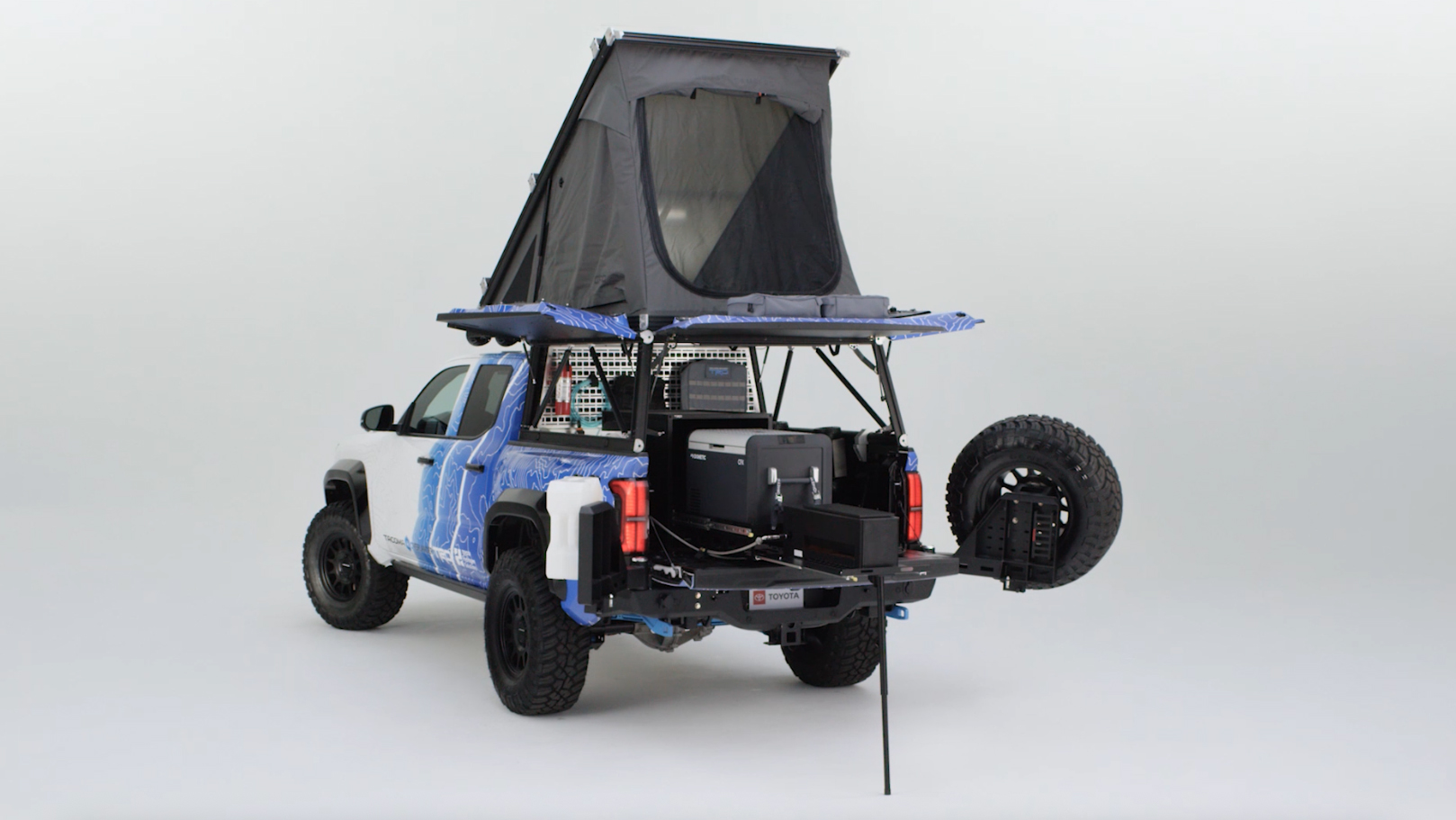 A Tacoma H2-Overlander truck in a studio