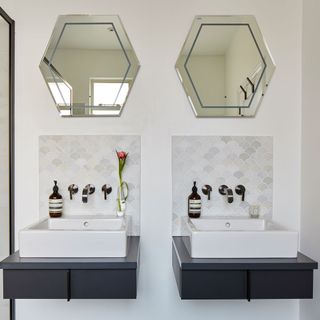 Bathroom with tiled splashbacks and hexagonal mirrors