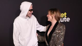 Pete Davidson in sweatpants next to Kaley Cuoco at the Meet Cute premiere.