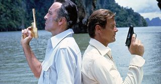 James Bond and Francisco Scaramanga stand back to back with pistols raised in The Man With The Golden Gun