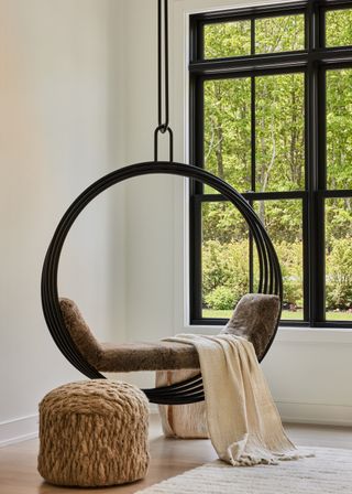 A pendant swing seater in the corner of the living room