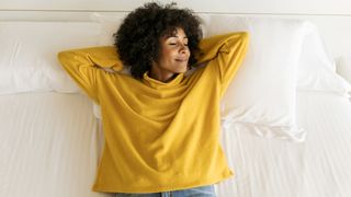How to choose a mattress for your preferred sleep position: a woman lies on her back on a mattress that offers the perfect level of firmness for her