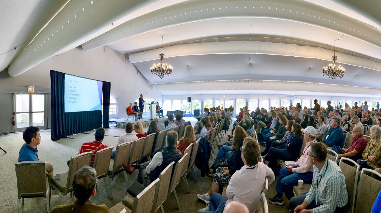 Attendees watch a presentation at a conference of &quot;Bogleheads&quot;