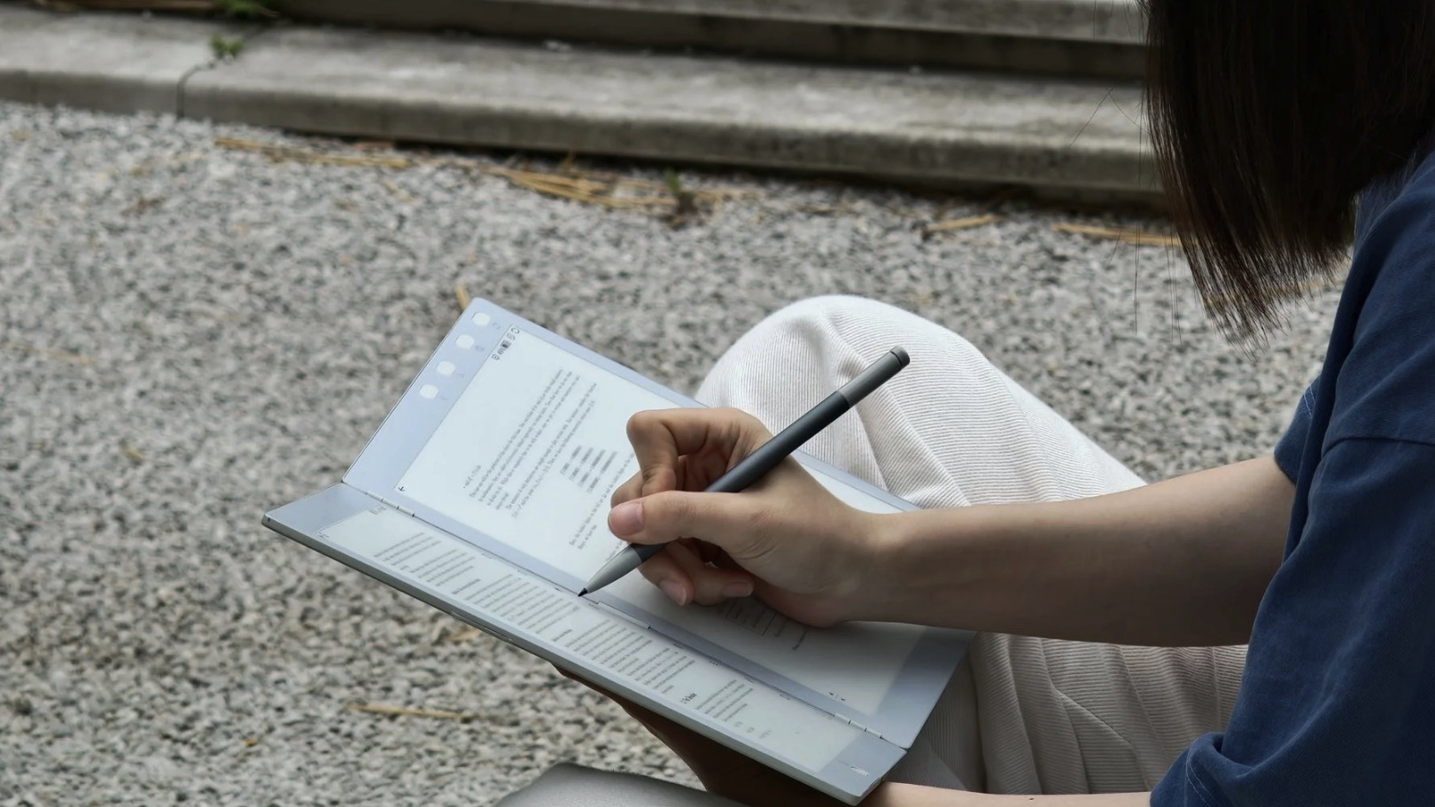 A woman taking notes on the InkLeaf