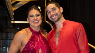 Ilona Maher and Alan Bersten smiling together in a BTS portrait from Dancing with the Stars. 