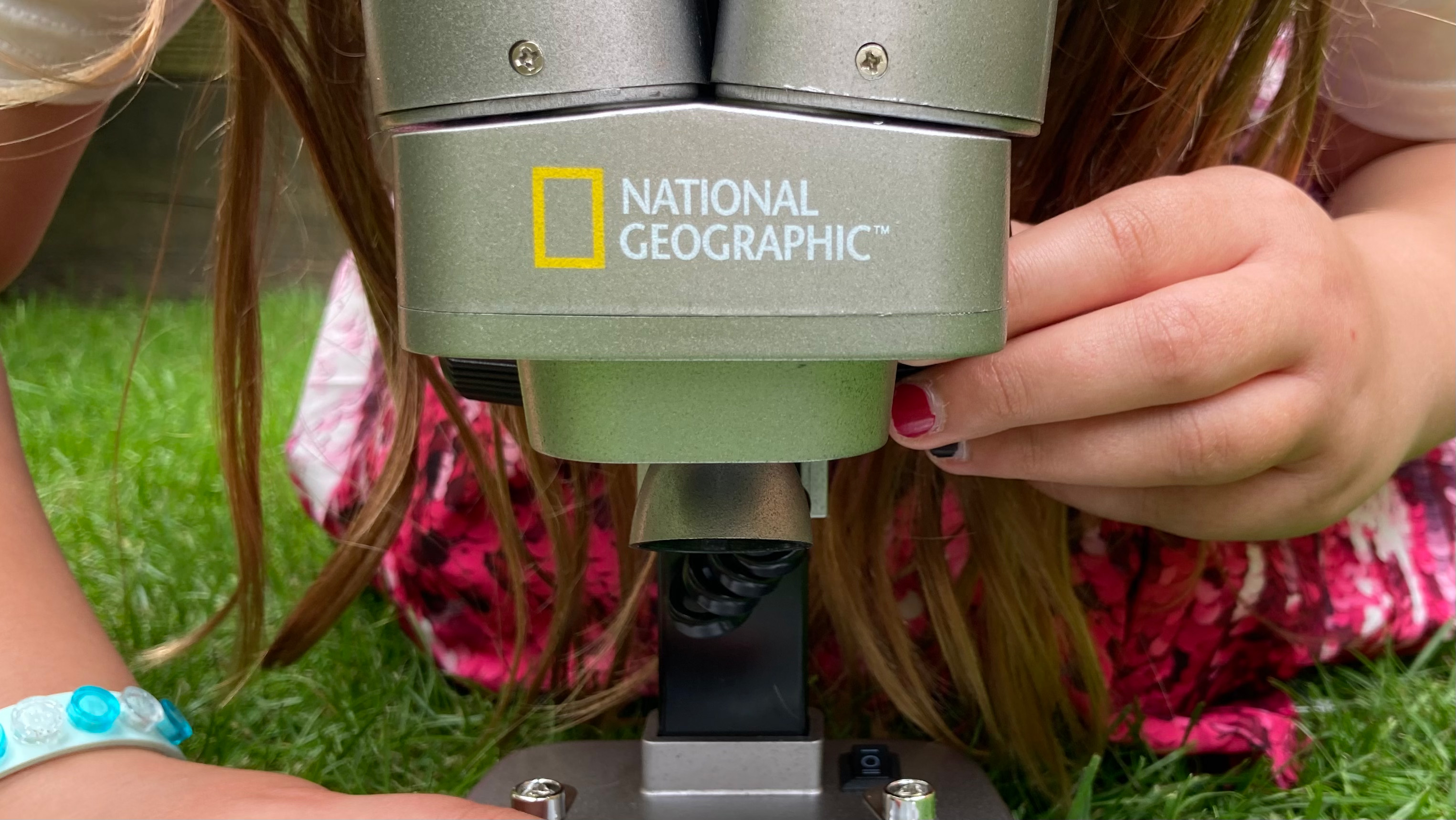 National Geographic Ultimate Dual Stereo Microscope being used by a child in a garden