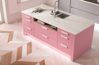 pink kitchen island with chevron wood flooring style