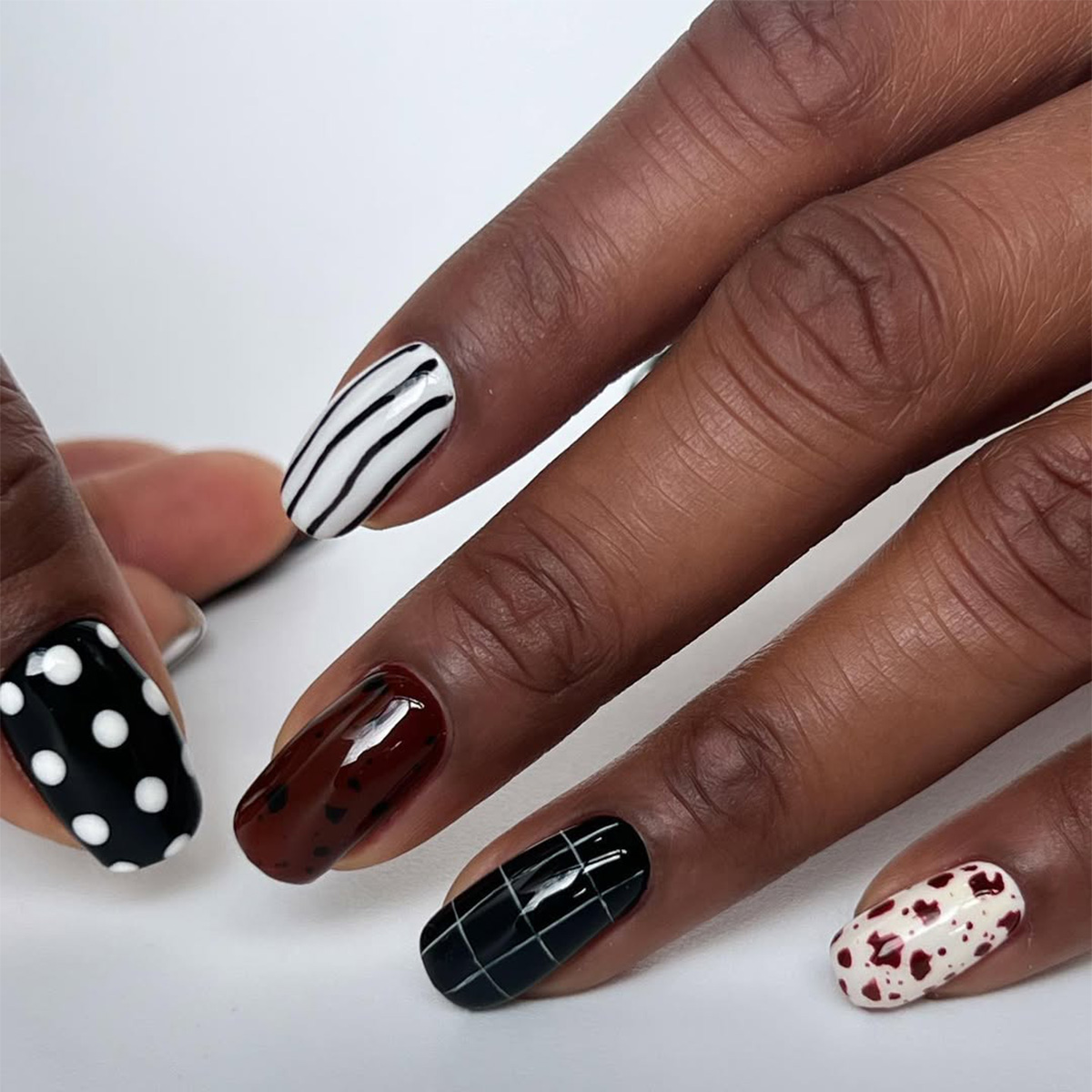 A manicure with graphic nail art by Paragon Nails.
