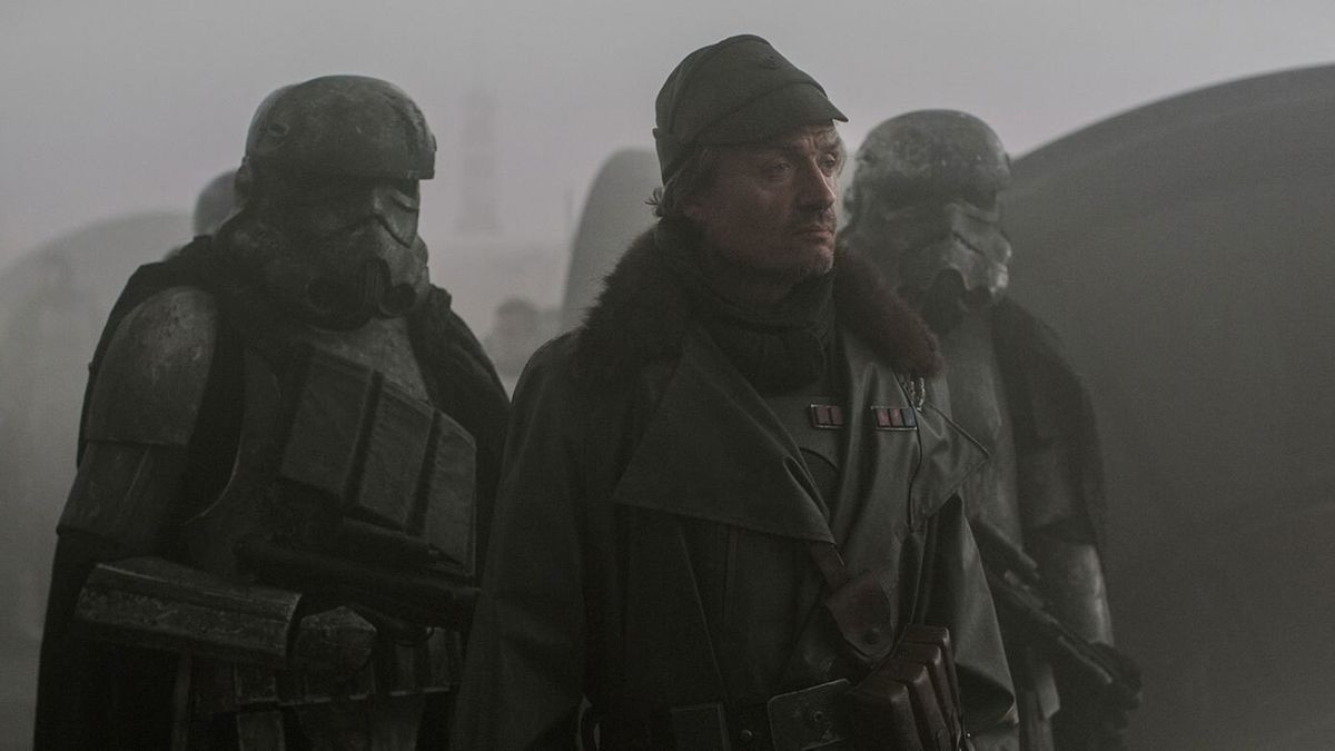 Still from a Star Wars show. Here we see an officer flanked by 2 very dirty stormtroopers holding big guns.