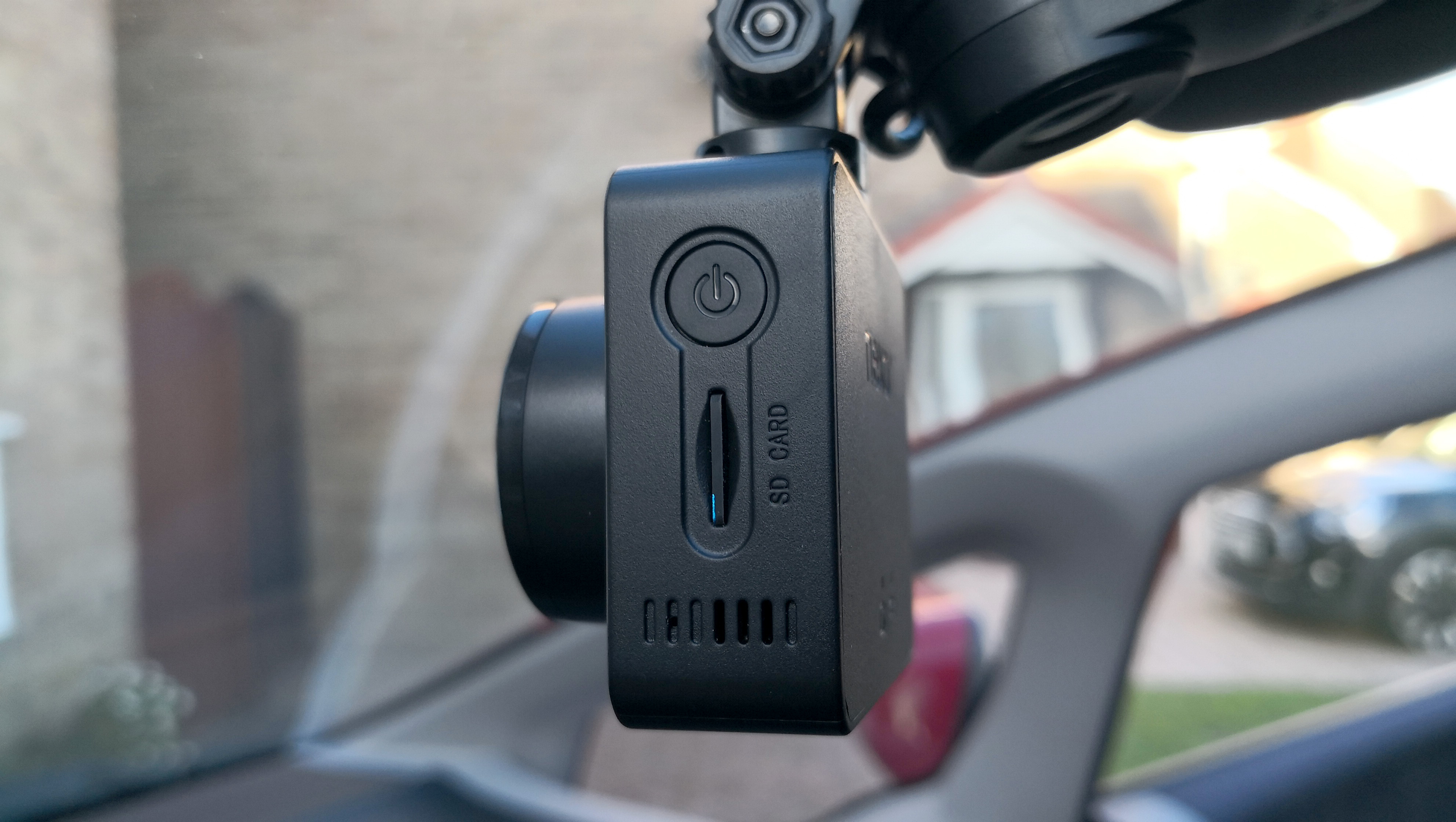 A dash cam mounted on the inside of a windscreen