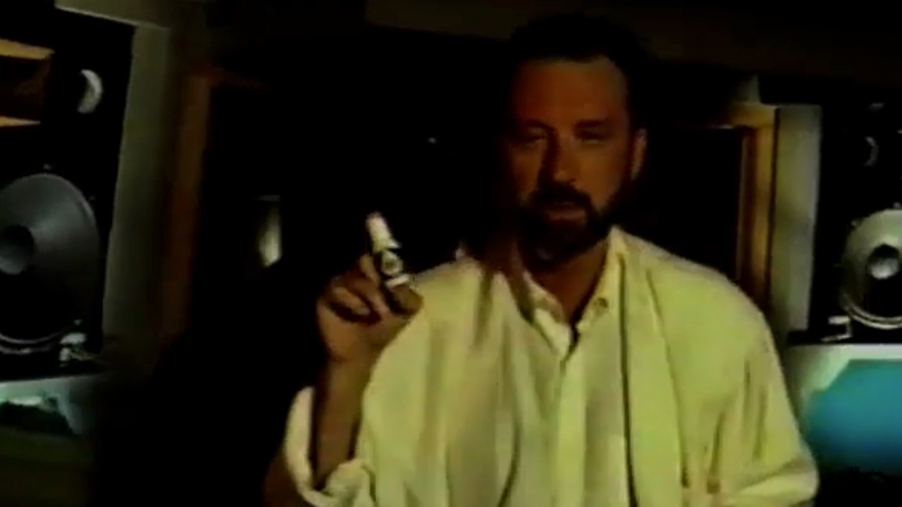 A screenshot of Michael Nesmith holding a bottle of liquid paper in a commercial from the 1960s