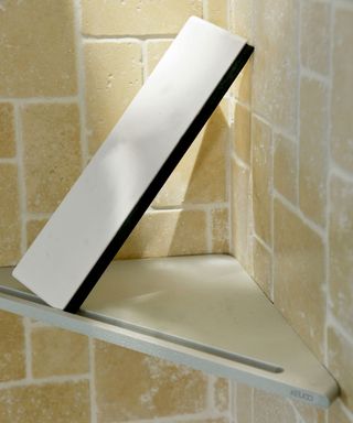 Keuco shower corner shelf on beige tiled background
