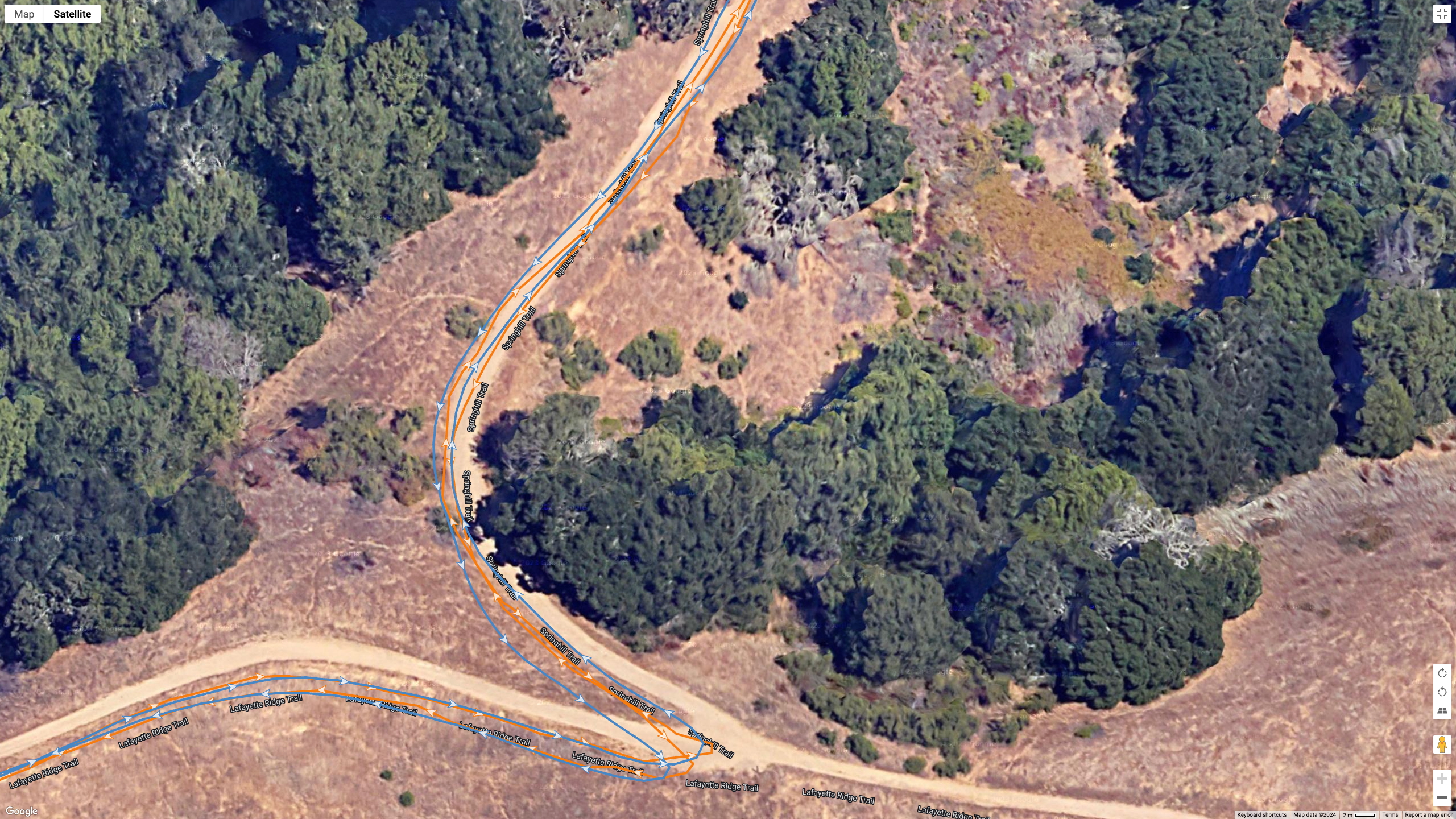 A Google Earth satellite image showing how the COROS PACE Pro (blue line) compares to the Garmin Fenix 8 (orange line) for a dual-band GPS accuracy test.