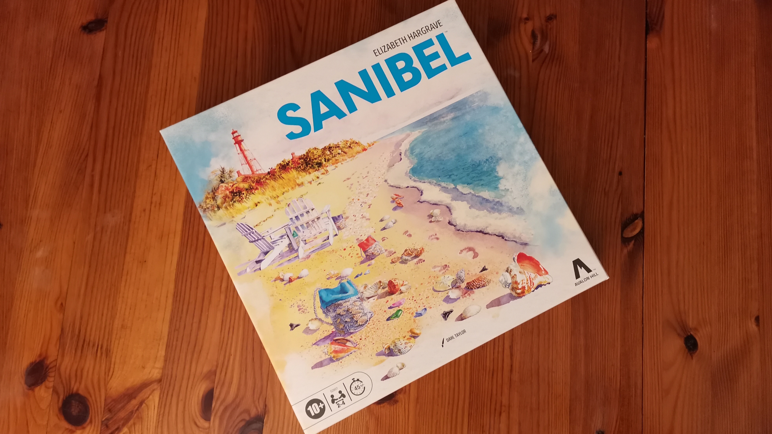 Sanibel board, tokens, and pieces on a wooden surface