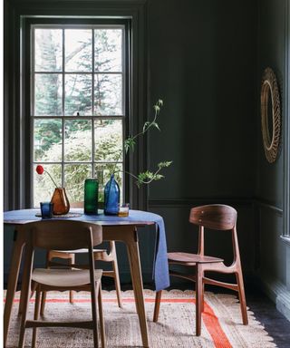 dining room with black walls and large window