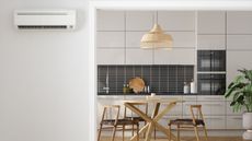 HVAC next to a kitchen with black tiles and wooden table