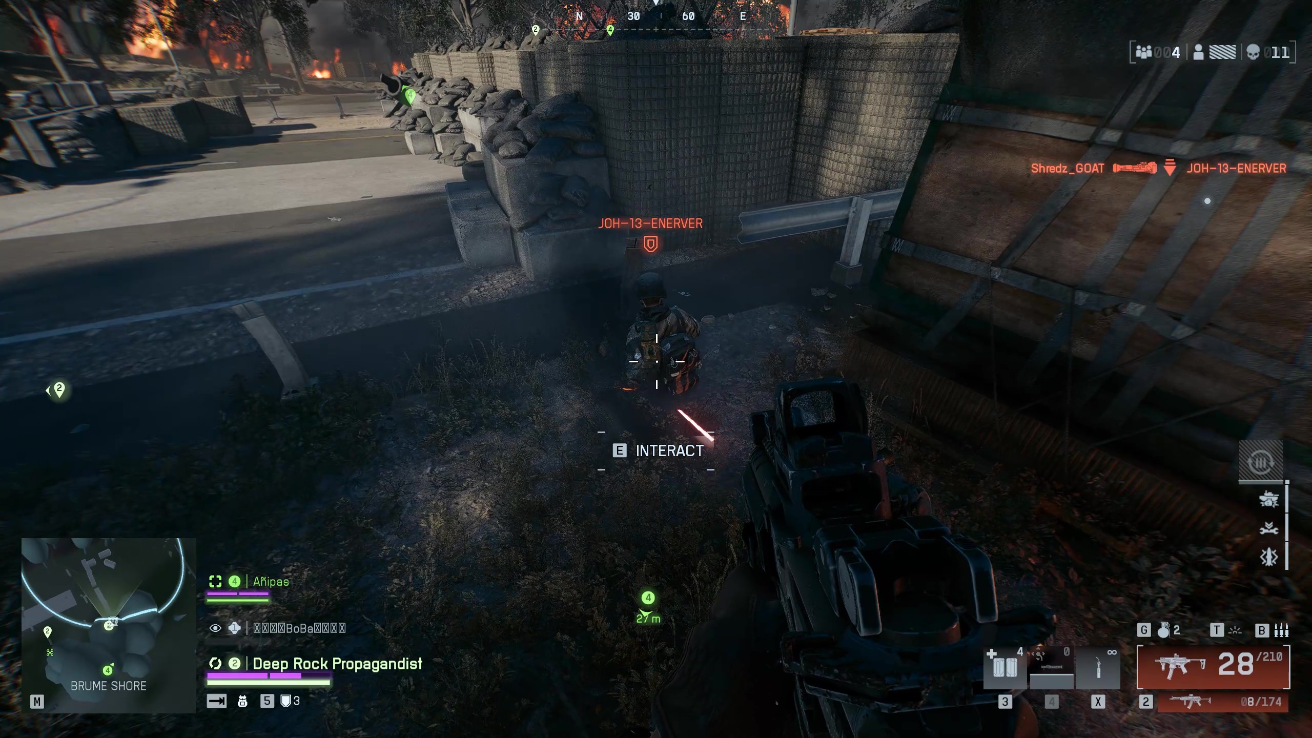 Battlefield 6 Redsec battle royale: A player looking at a downed enemy near a crate and sandboxes on the side of a highway.