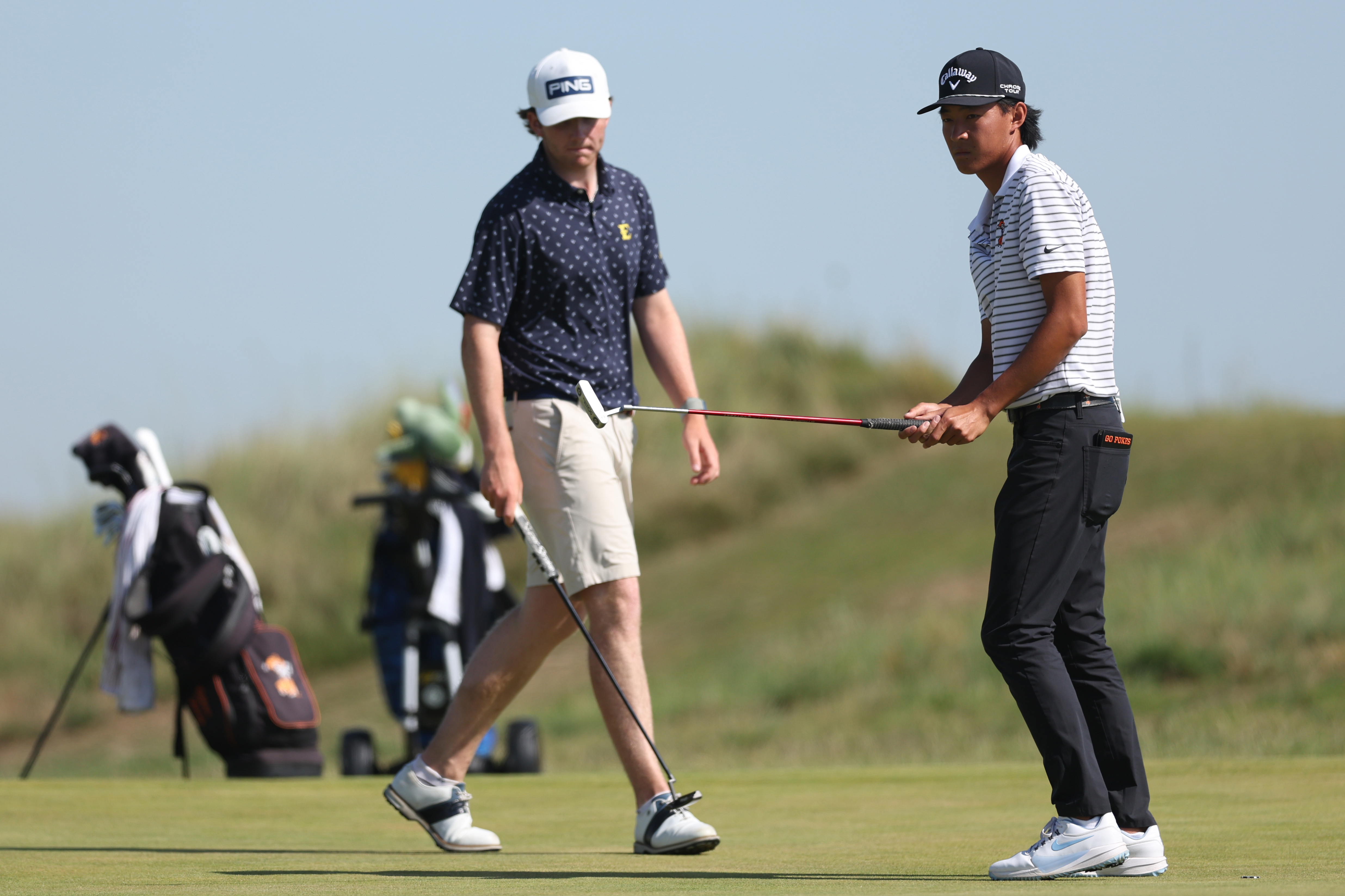Gavin Tiernan and Ethan Fang watch a putt