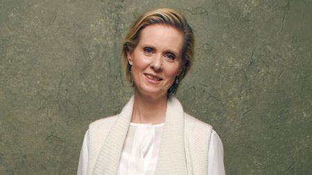 cynthia nixon on a green background