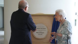 Queen Elizabeth II unveils a plaque during a visit to officially open the new building at Thames Hospice on July 15, 2022 in Maidenhead, England.