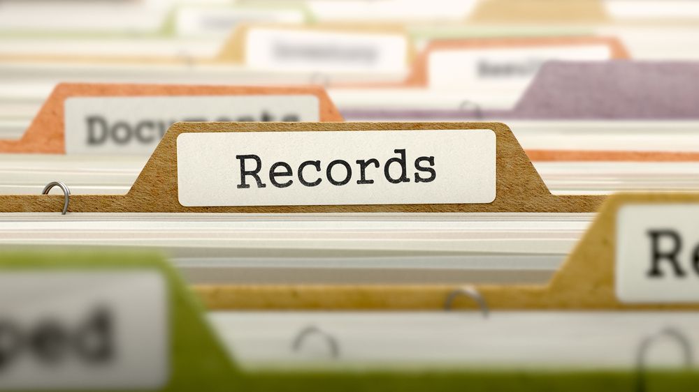 Close up of a paper filing system with a divider labelled &amp;quot;Records&amp;quot;. 