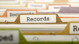 Close up of a paper filing system with a divider labelled "Records". 