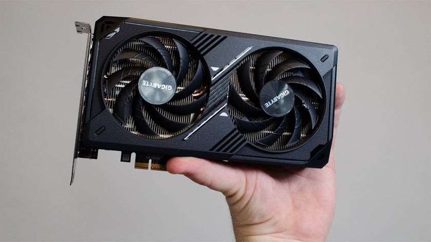 An Nvidia RTX 5060 held in a masculine hand