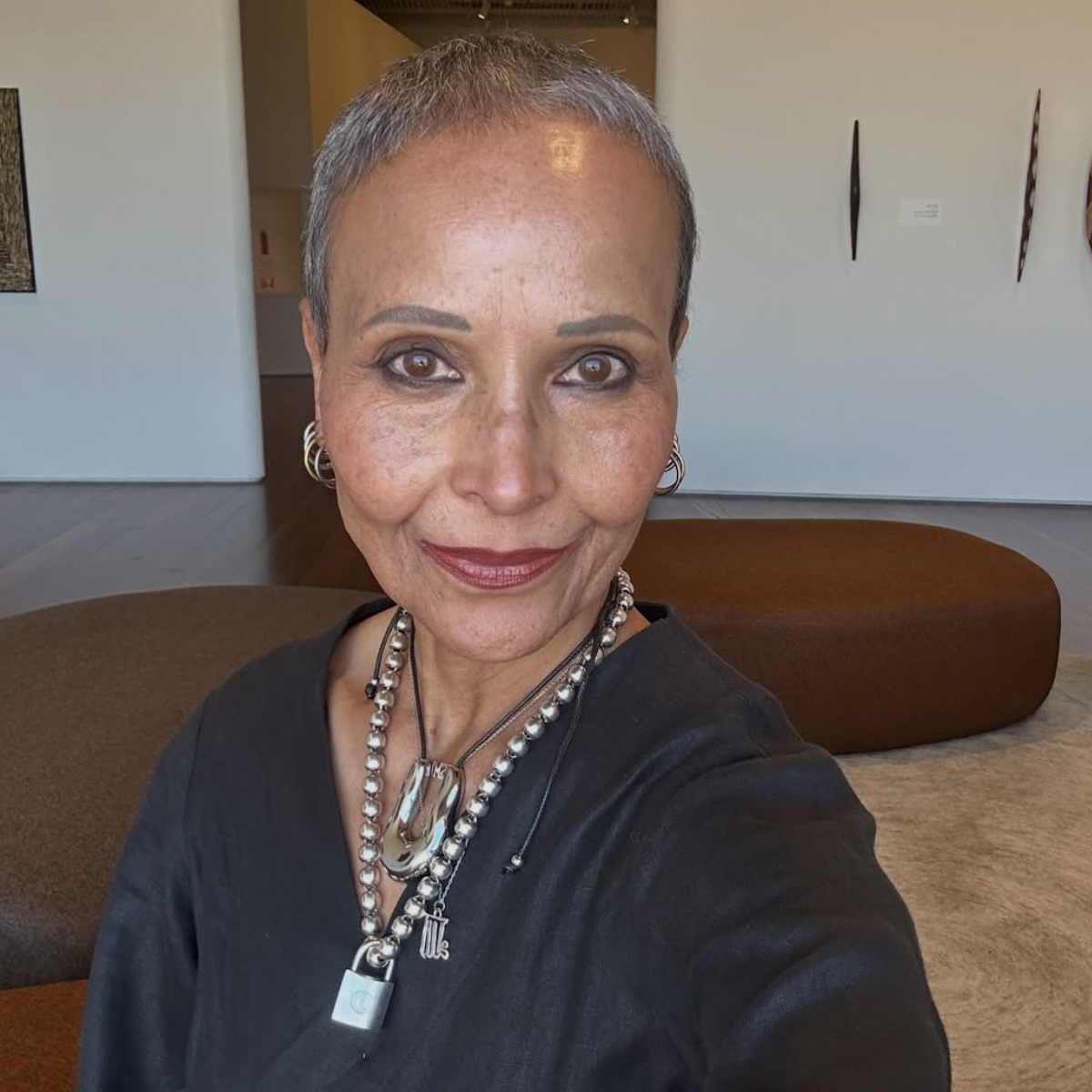 Yasmin wearing a black top and silver statement jewellery