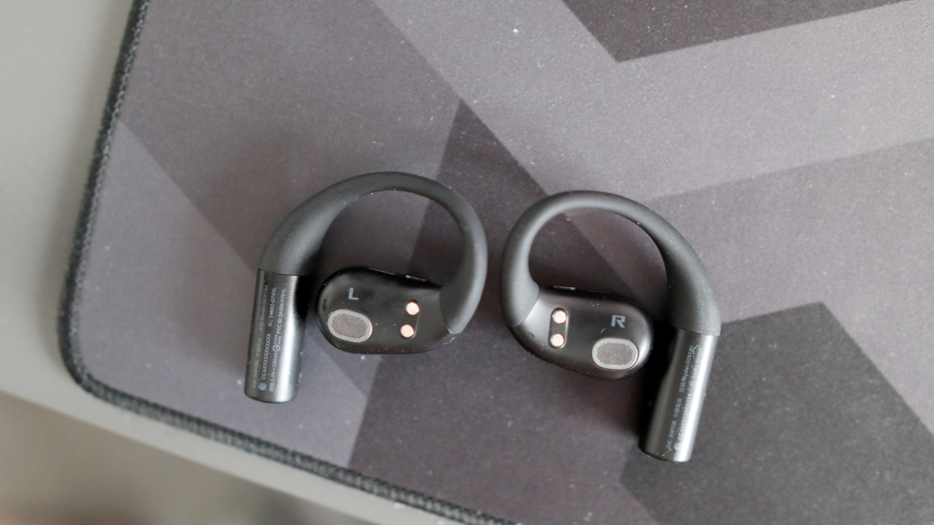 Asus ROG Cetra Open earbuds on a deskmat.