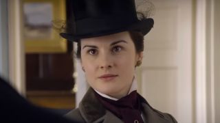 Michelle Dockery wears a cutting look while in conversation in Downton Abbey.