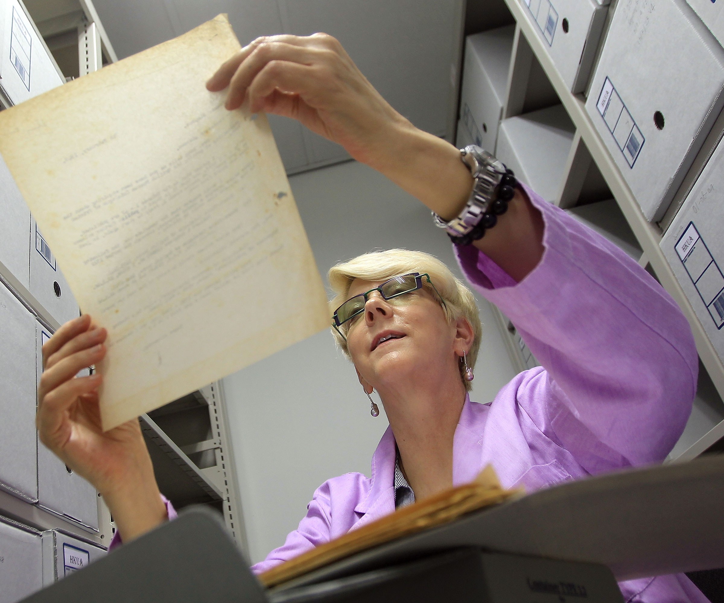 woman looking through old archives
