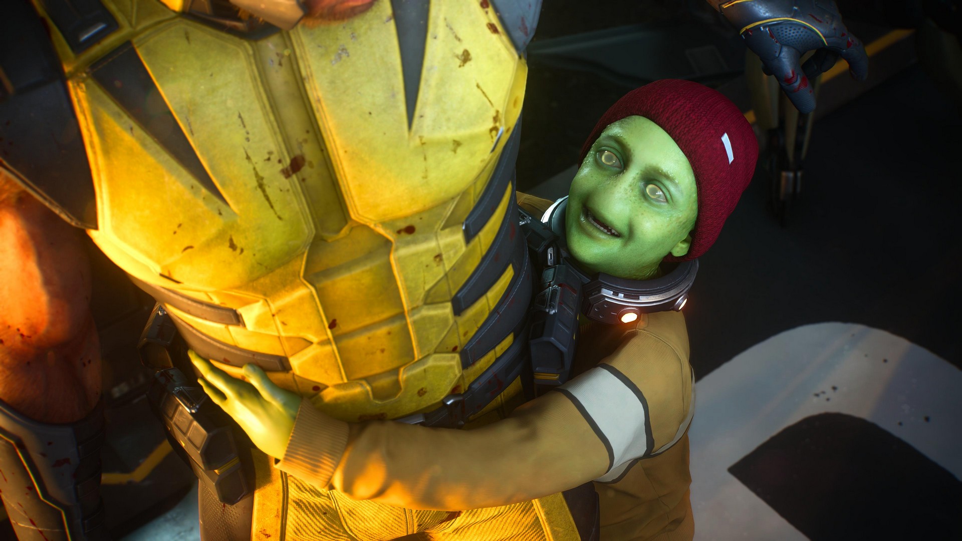 Logan stiffens up as Leech, a child mutant who is green, gives him a big hug in Marvel's Wolverine