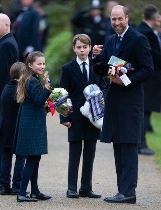 Prince George, Prince Louis, Princess Charlotte, and Prince William carry gifts from royal fans at Sandringham on Christmas Day