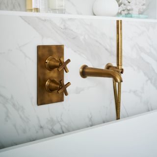 Marble bathroom close-up with brushed brass hardware