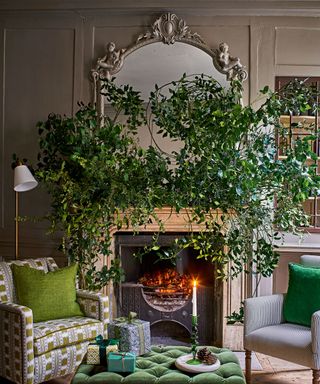 Festive living room with fireplace dressed in foliage