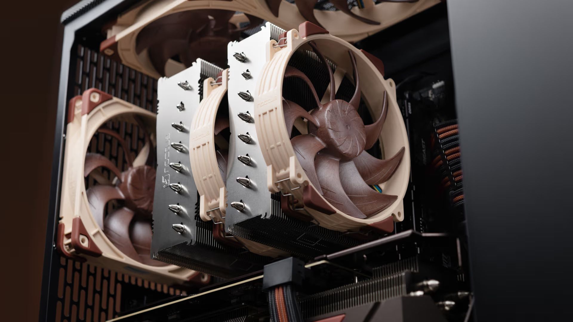 A marketing image of one of Noctua's larger CPU coolers in an open PC case