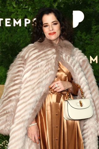 Parker Posey wears a white Gucci bag in NYC