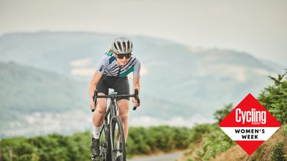 Image shows a female riding cycling up a hill