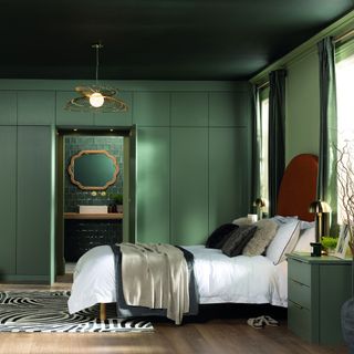 bedroom with green walls and ceiling and green fitted wardrobes