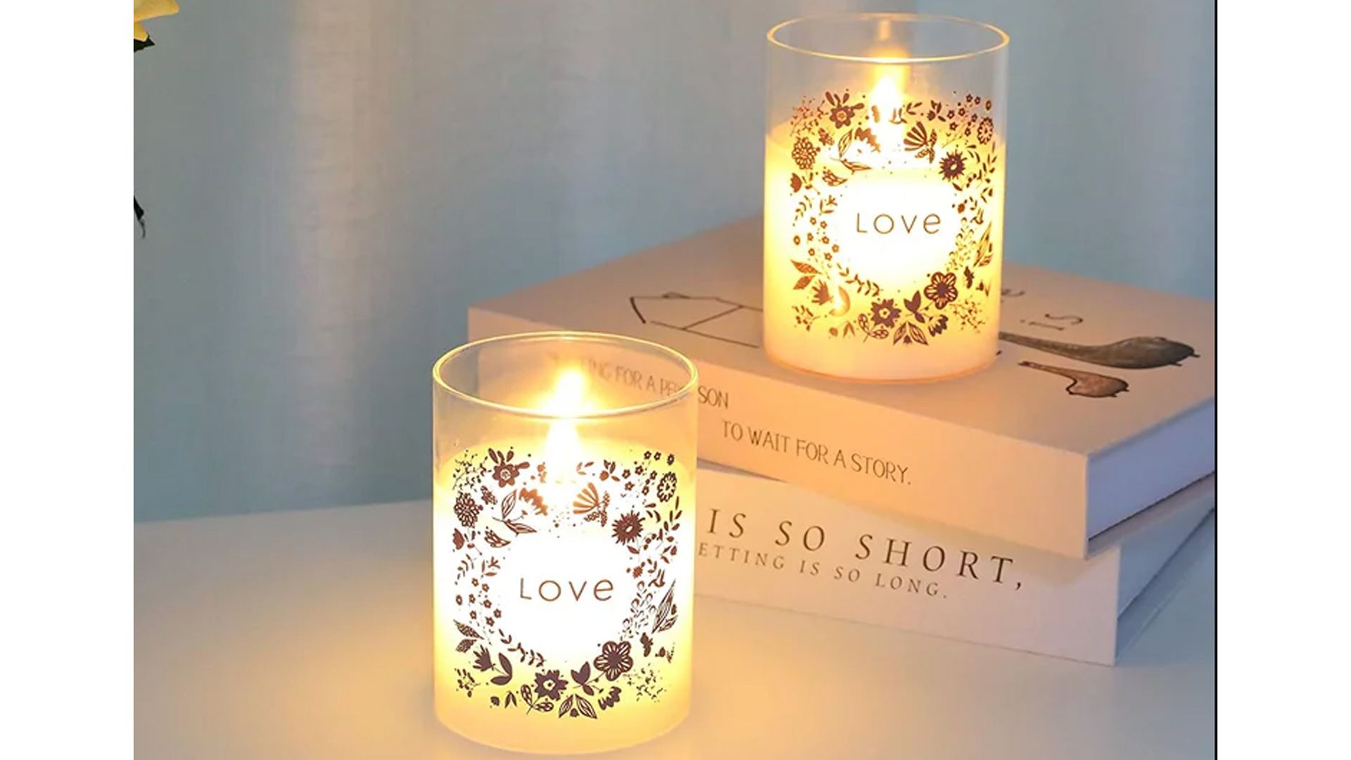 Flameless candles in glass votives with love inscribed on the outside