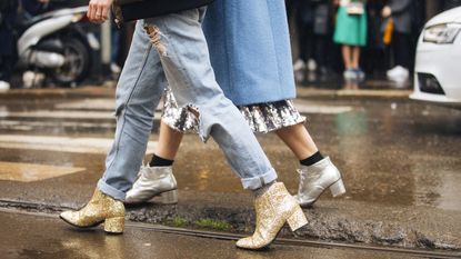 two women with two different types of boots: gold chunky boots and silver heeled boots