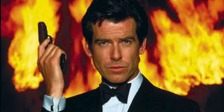 Goldeneye Pierce Brosnan holding a gun, in front of a fiery background